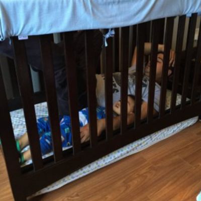 lowered crib mattress to the floor inside the crib